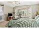 Bright bedroom with large windows, neutral walls, and ceiling fan at 7003 S 23Rd Ln, Phoenix, AZ 85041
