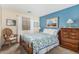 Cozy bedroom with blue accent wall and dresser at 7003 S 23Rd Ln, Phoenix, AZ 85041