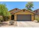 Charming single-story home with a well-manicured lawn, two-car garage and desert landscaping at 7003 S 23Rd Ln, Phoenix, AZ 85041