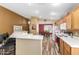 Open concept kitchen with stainless appliances, marble countertops, wood floors, and breakfast bar at 7003 S 23Rd Ln, Phoenix, AZ 85041