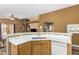 Open concept kitchen featuring counter seating, a stainless steel sink, and tile flooring at 7003 S 23Rd Ln, Phoenix, AZ 85041