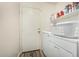 Convenient laundry area with washer, dryer, shelving and easy access to the back door at 7003 S 23Rd Ln, Phoenix, AZ 85041