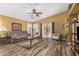 Spacious living room with tile floors, ceiling fan, and sliding glass doors to the patio at 7003 S 23Rd Ln, Phoenix, AZ 85041