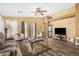 Bright and open living room featuring tile floors, comfortable seating, and a ceiling fan at 7003 S 23Rd Ln, Phoenix, AZ 85041