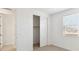 Bright bedroom featuring a window, sliding closet doors, and neutral carpet at 7384 W Buckhorn Trl, Peoria, AZ 85383
