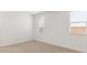 Light-filled bedroom with neutral carpet, white walls, and two windows at 7384 W Buckhorn Trl, Peoria, AZ 85383