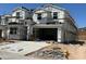 New two story home under construction with an attached two car garage and a concrete driveway at 7384 W Buckhorn Trl, Peoria, AZ 85383