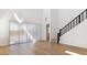 Bright living room featuring a staircase, high ceiling, and sliding glass doors at 7384 W Buckhorn Trl, Peoria, AZ 85383