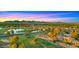 Stunning aerial view showcasing the community, golf course, ponds, and mountain backdrop at sunset at 7424 N Via Camello Del Norte -- # 185, Scottsdale, AZ 85258