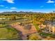 Aerial view of home in a golf course community with mature trees, lake and mountain views at 7424 N Via Camello Del Norte -- # 185, Scottsdale, AZ 85258