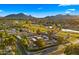 Aerial view of neighborhood on the golf course with mountain views and blue skies at 7424 N Via Camello Del Norte -- # 185, Scottsdale, AZ 85258