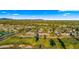 An aerial view of a home on a golf course with a community and mountain backdrop at 7424 N Via Camello Del Norte -- # 185, Scottsdale, AZ 85258