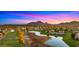 Breathtaking aerial view showcasing the community's scenic golf course, lakes, and stunning mountain backdrop at 7424 N Via Camello Del Norte -- # 185, Scottsdale, AZ 85258