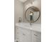 Bathroom featuring a round mirror, quartz countertop, and modern fixtures, perfect for a clean aesthetic at 7424 N Via Camello Del Norte -- # 185, Scottsdale, AZ 85258