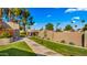 Exterior view of lush lawn, sidewalk, and flowering bushes at 7424 N Via Camello Del Norte -- # 185, Scottsdale, AZ 85258