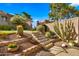 Landscaped front entrance with a stairway leading to the home, enhancing curb appeal and accessibility at 7424 N Via Camello Del Norte -- # 185, Scottsdale, AZ 85258