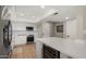 Updated kitchen with white cabinets, stainless steel appliances, quartz countertops, and a wine cooler at 7424 N Via Camello Del Norte -- # 185, Scottsdale, AZ 85258