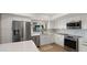 Modern kitchen with stainless steel appliances, white cabinets, quartz countertops, and decorative tile backsplash at 7424 N Via Camello Del Norte -- # 185, Scottsdale, AZ 85258