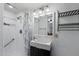 Clean bathroom featuring a modern sink, shower with patterned curtain, and mirrored cabinet at 772 Leisure World --, Mesa, AZ 85206