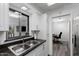Modern kitchen with stainless steel sink, bright window, and a view into an adjacent office at 772 Leisure World --, Mesa, AZ 85206