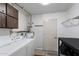Functional laundry room with washer, dryer, storage cabinets and utility sink at 772 Leisure World --, Mesa, AZ 85206