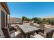 Outdoor dining area with a large fire table surrounded by comfortable wicker chairs, perfect for entertaining at 772 Leisure World --, Mesa, AZ 85206