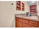 Cozy bathroom featuring updated vanity, framed mirror, and accent shelving for storage at 8202 N 21St Dr # B101, Phoenix, AZ 85021