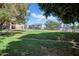 Community green space offering grassy play area with mature trees creating natural shade and comfortable outdoor living at 8202 N 21St Dr # B101, Phoenix, AZ 85021