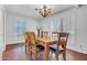 Elegant dining room features modern lighting fixture with shuttered windows illuminating a wooden dining table set at 8202 N 21St Dr # B101, Phoenix, AZ 85021