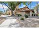 Charming home with a tile roof and desert landscaping, shaded by mature trees, creating curb appeal at 8202 N 21St Dr # B101, Phoenix, AZ 85021