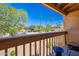 View from the balcony with a table set and tree-lined street views on a sunny day at 8414 N Central Ave # C, Phoenix, AZ 85020