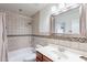 Bright bathroom featuring a tiled shower-tub with a decorative accent and a modern sink at 8414 N Central Ave # C, Phoenix, AZ 85020