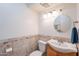 Cozy bathroom with a decorative mirror, wood vanity, and tiled backsplash at 8414 N Central Ave # C, Phoenix, AZ 85020