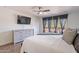 Bedroom with a ceiling fan and sliding door to a balcony with tree views at 8414 N Central Ave # C, Phoenix, AZ 85020