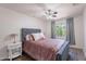 Cozy bedroom with tufted headboard, ceiling fan, and natural light from the window at 8414 N Central Ave # C, Phoenix, AZ 85020
