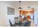 Inviting dining area with a glass table, comfortable seating, and an open view to the modern kitchen at 8414 N Central Ave # C, Phoenix, AZ 85020