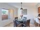 Bright dining area featuring a modern pendant light and view of the outdoor patio at 8414 N Central Ave # C, Phoenix, AZ 85020