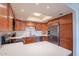 Well-lit kitchen with warm wood cabinets, stainless steel appliances, and bright countertop space at 8414 N Central Ave # C, Phoenix, AZ 85020