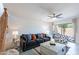 Spacious living room with neutral decor, modern ceiling fan, and access to outdoor patio at 8414 N Central Ave # C, Phoenix, AZ 85020