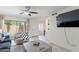 Bright living room with ceiling fan, tiled floors, and sliding glass door to outdoor seating area at 8414 N Central Ave # C, Phoenix, AZ 85020
