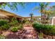 Picturesque backyard featuring a covered patio, mature trees, and a charming water fountain at 8540 W Wescott Dr, Peoria, AZ 85382