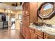 Elegant bathroom with granite counters, dark wood cabinets, and unique black vessel sink at 8540 W Wescott Dr, Peoria, AZ 85382