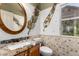 Bathroom with granite countertop vanity, stylish mirror, and decorative leaf accents at 8540 W Wescott Dr, Peoria, AZ 85382