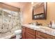 Charming bathroom featuring granite counter, wood cabinets and walk-in shower at 8540 W Wescott Dr, Peoria, AZ 85382