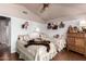 Cozy bedroom featuring two twin beds with charming quilts and unique teddy bear decor at 8540 W Wescott Dr, Peoria, AZ 85382