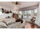 Bright and cozy bedroom with wood floors, natural light, and charming decor at 8540 W Wescott Dr, Peoria, AZ 85382