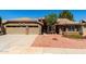 Inviting single-story home boasts stone accents, a two-car garage, and mature landscaping at 8540 W Wescott Dr, Peoria, AZ 85382