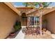 A pathway leads to the ornate front doors framed by stone accents and lush landscaping at 8540 W Wescott Dr, Peoria, AZ 85382