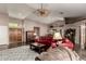 Inviting living room featuring dark hardwood floors, a comfortable seating arrangement, and ample natural light at 8540 W Wescott Dr, Peoria, AZ 85382