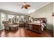 Comfortable primary suite with hardwood floors, bay window, seating area, and large dark wood bed at 8540 W Wescott Dr, Peoria, AZ 85382